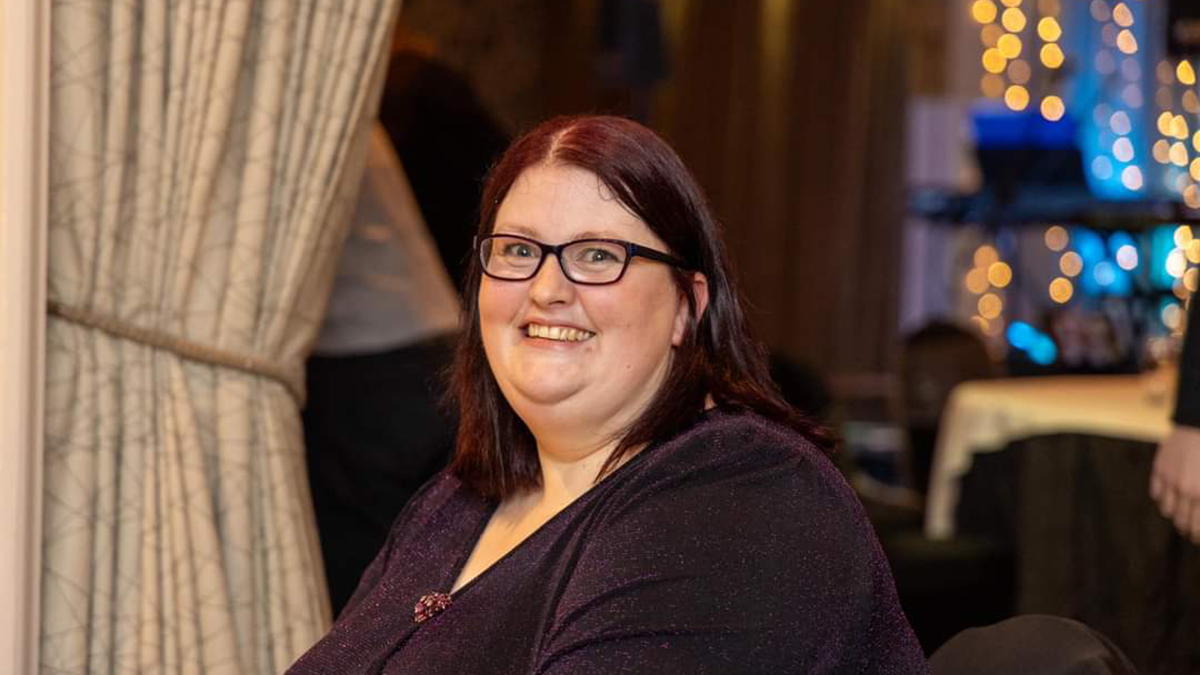 Head shot of Rachel Fraser, with dark hair and glasses