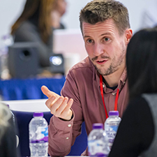 bobby speaking to a table of people