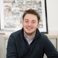 Jordan McNeilage sitting at his desk