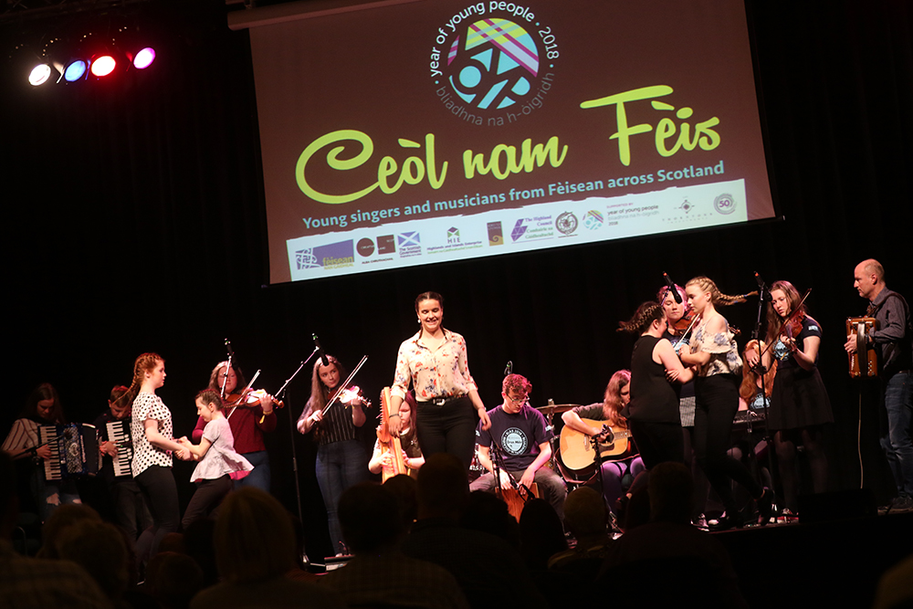 Young singers and musicians performing on stage