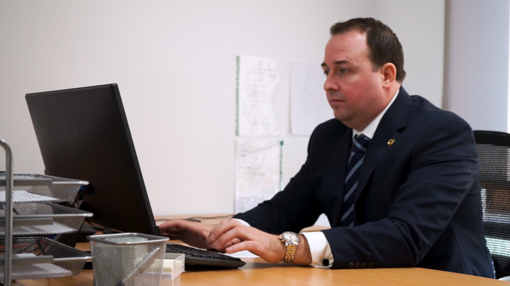 Man sitting at a desk using a laptop