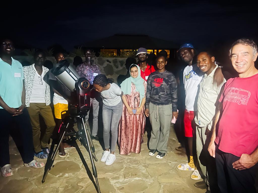 Professor Melvin Hoare with students during their first experience of looking through the 20cm optical telescope