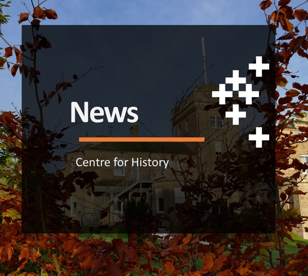 Large building seen through shrubs of autumn colour in red green and yellow. Text reads News Centre for History