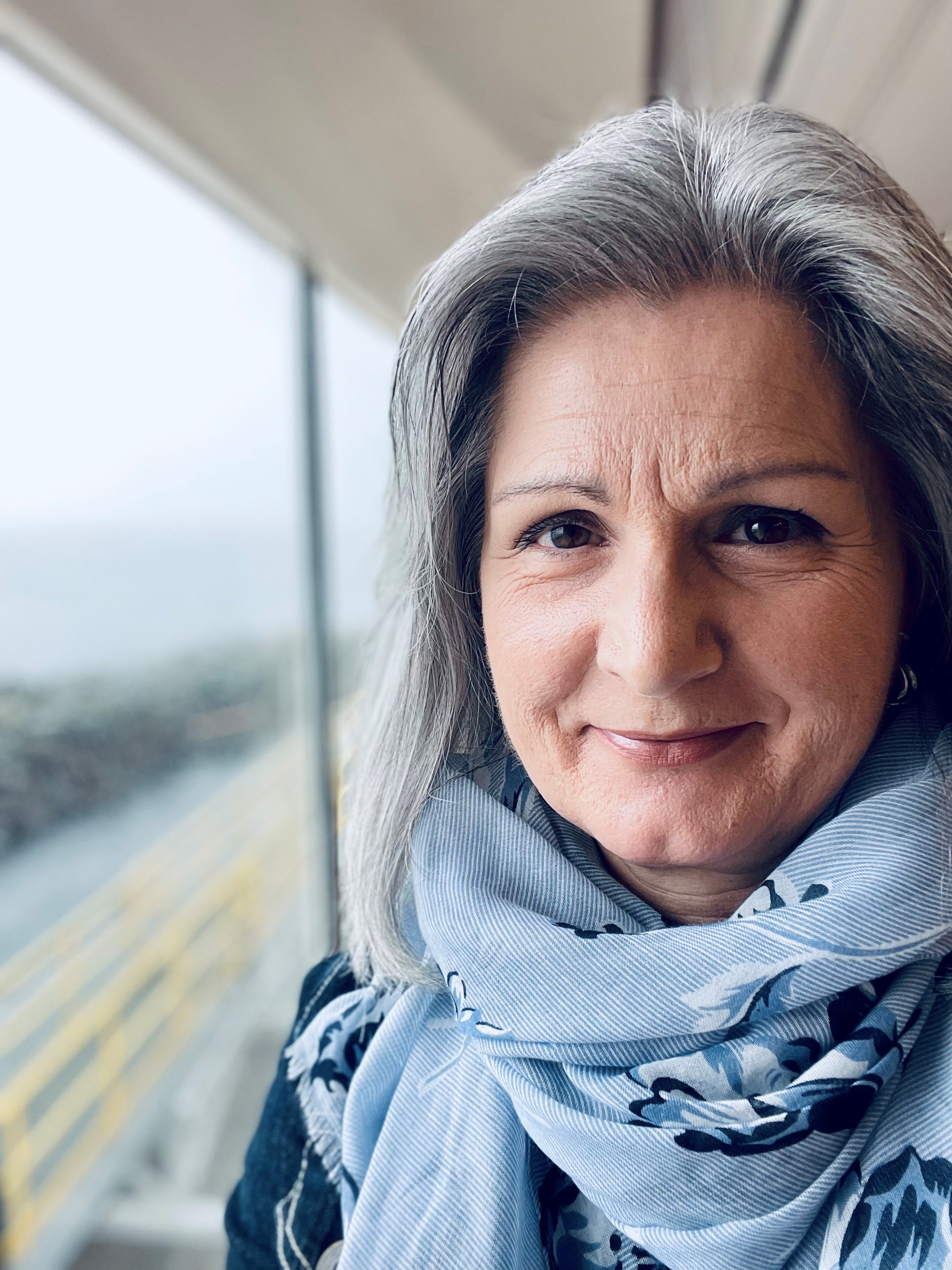 Close up photograph of a woman, with the background softly out of focus.