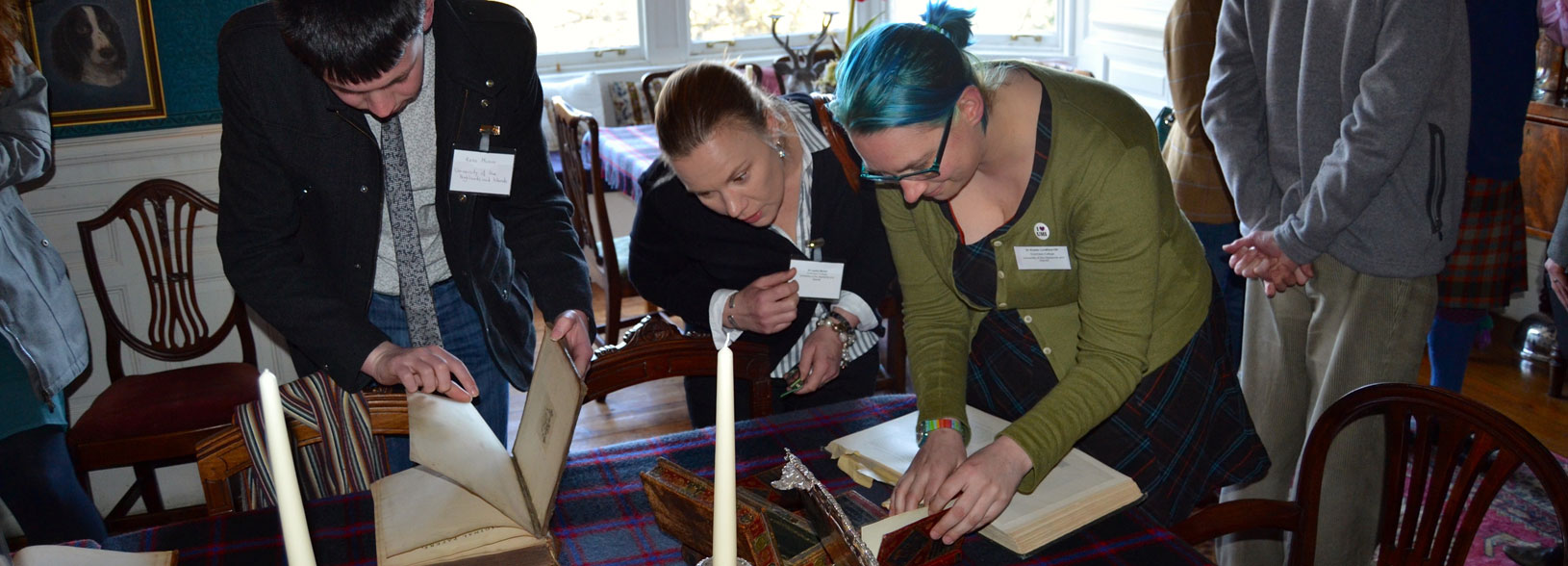 Group of people inspecting books