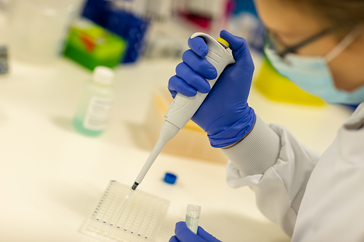 A scientist using a pipette