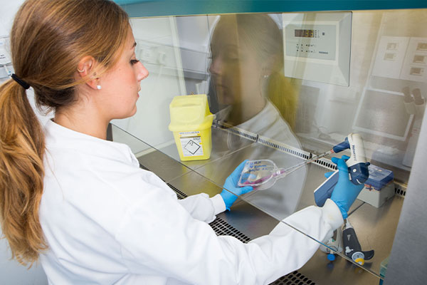 Female student using equipment in the lab