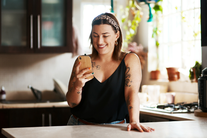 A student smiling at her mobile phone